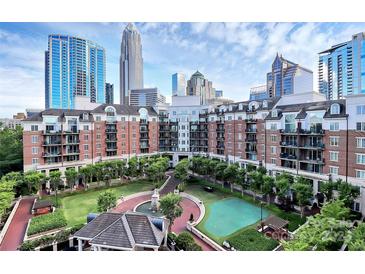 Beautiful courtyard view of a luxury building with lush landscaping and walkways in a vibrant urban setting at 300 W 5Th St # 644, Charlotte, NC 28202
