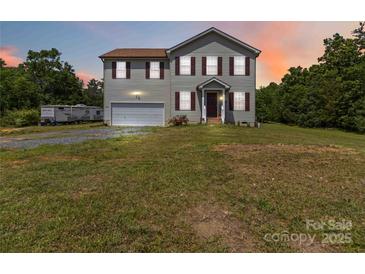 Charming two-story home with attached garage and well-maintained lawn at 3401 Shillinglaw Rd, Sharon, SC 29742