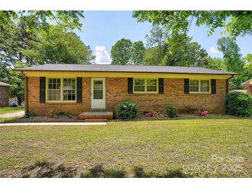 Charming brick home with a well-manicured front lawn and classic black shutters at 3455 Hickory Pl, Salisbury, NC 28144