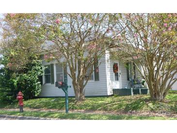 Charming home with mature trees and flowering shrubs accenting the front yard at 402 E Long Ave, Gastonia, NC 28054