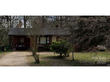 Charming one-story brick home with a large front yard and driveway, perfect for Gathering living at 13134 Homewood Dr, Charlotte, NC 28262