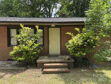 Charming brick home featuring a welcoming front entrance with a well-maintained landscape at 13134 Homewood Dr, Charlotte, NC 28262