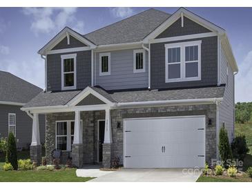 Charming two-story home with a stone and gray facade, complemented by a spacious two-car garage at 145 Satchel Ct, Mooresville, NC 28115