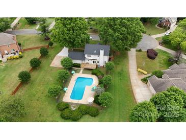A home with a backyard pool surrounded by landscaped grounds in a well-kept neighborhood at 188 Turnberry Ln, Mooresville, NC 28117