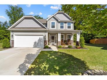 Charming two-story home with a well-maintained lawn and inviting front porch at 3615 Alamito Ln, Charlotte, NC 28214