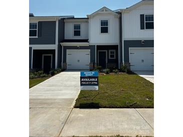 Charming townhouse with a well-manicured lawn and a 'move-in ready' sign at 4213 Summit Woods Dr, Charlotte, NC 28216