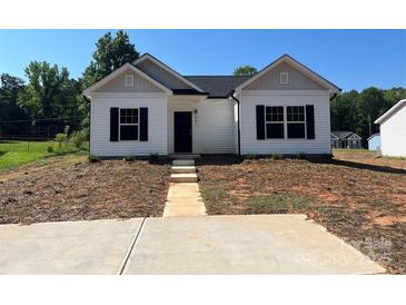 Charming single-story home with a symmetrical design and a well-manicured front lawn at 601 Queens Rd, Gastonia, NC 28052