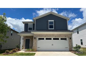 Charming two-story home features a brick and blue vinyl exterior with an attached two-car garage at 820 Blue Canyon Dr, York, SC 29745