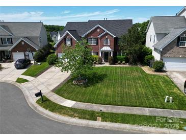 Beautiful brick home featuring a well-manicured lawn and a classic, symmetrical design at 9612 Indian Beech Nw Ave # 1266, Concord, NC 28027
