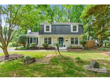 Charming two-story home with landscaped yard, mature trees, and a welcoming front porch at 1014 Vandalia Dr, Charlotte, NC 28212
