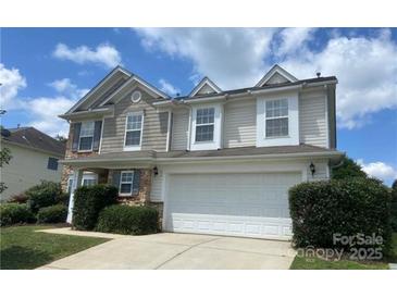 Charming two-story home featuring stone accents, a two-car garage, and a well-manicured front lawn at 10418 Cullen Ct, Charlotte, NC 28278