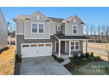 Charming two-story home with attached two-car garage and landscaped yard at 14113 New Crest Ln # 162, Huntersville, NC 28078