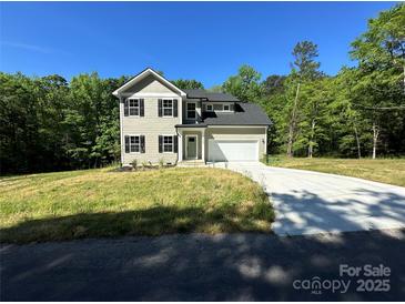 Charming two-story home with a well-manicured lawn, attached garage, and classic architectural details at 1563 Riverview Cir, Fort Lawn, SC 29714