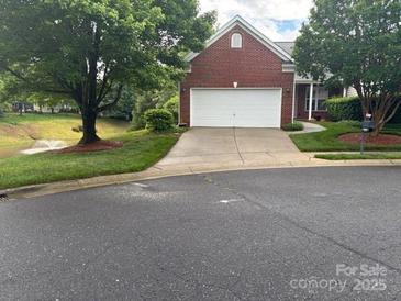 Charming brick home featuring a well-manicured lawn and an attached two-car garage at 1678 Onyx Rdg, Fort Mill, SC 29708