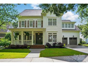 Charming two-story home with a covered front porch, beautiful lawn, and two-car garage at 201 Mills Ln, Fort Mill, SC 29708