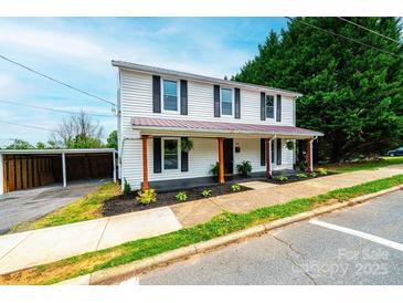 Charming two-story home with a covered front porch and an adjacent carport at 210 W 15Th St, Newton, NC 28658
