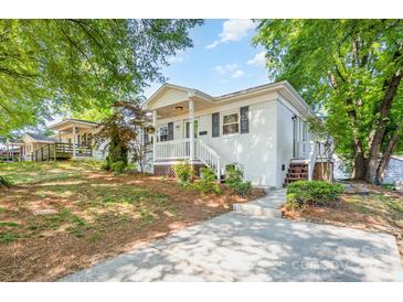 Charming white brick home with a cozy front porch, landscaped yard, and inviting curb appeal at 2109 Brewton Dr, Charlotte, NC 28206