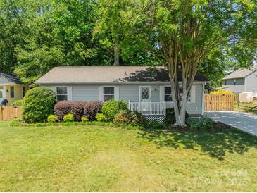 Charming single-story home with well-manicured lawn and welcoming front porch, perfect for relaxing outdoors at 21614 Colina Dr, Cornelius, NC 28031