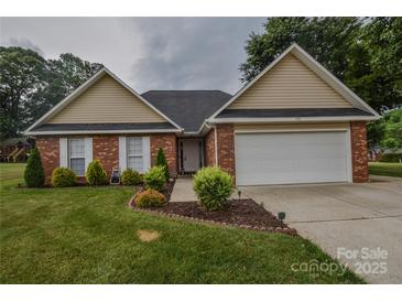 Charming single-story brick home with well-manicured lawn and attached two-car garage at 330 Kilmer Ln, Mooresville, NC 28115