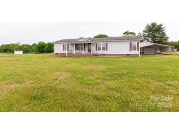 Well-maintained single-story home with a large front yard and covered porch, perfect for enjoying the outdoors at 404 St Lukes Church Rd, Kings Mountain, NC 28086