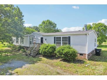 Charming single-Gathering home with a landscaped front yard and inviting entryway at 4122 Canal Rd, Marshville, NC 28103
