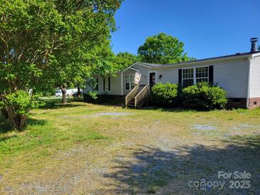 Charming single-story home with a welcoming front porch and well-maintained lawn and attractive landscaping at 4122 Canal Rd, Marshville, NC 28103