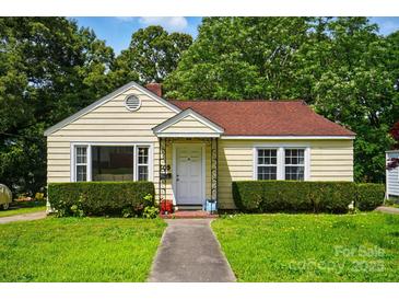 Charming yellow bungalow with red roof, landscaped front yard, and inviting front porch entrance at 509 S Clay St, Gastonia, NC 28052
