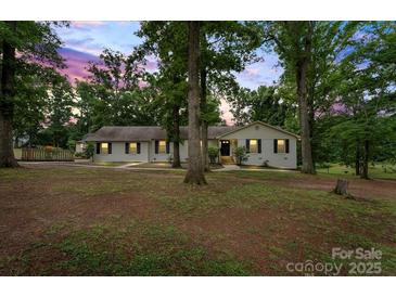 Charming one-story home featuring a lush front yard and inviting walkway at 603 Sunnybrook Dr, Monroe, NC 28110