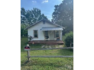 Quaint one-story home with covered porch and mature trees at 126 N Kendall St, Norwood, NC 28128