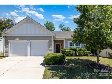 Charming home featuring a well-manicured lawn, neatly trimmed shrubs, and a convenient two-car garage at 12792 Clydesdale Dr, Midland, NC 28107