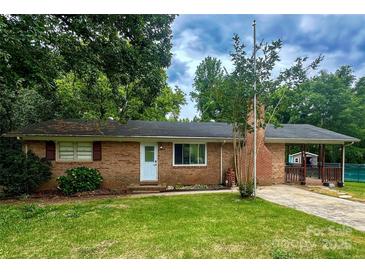 Charming single-story brick home with a well-maintained lawn and mature trees at 128 Paul Snipes Rd, Lancaster, SC 29720
