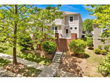 Charming two-story home with manicured landscaping and inviting front porch and stairway at 14940 Carbert Ln, Huntersville, NC 28078