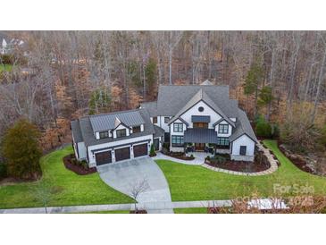 Stunning home with three car garage, manicured lawn and mature trees at 17416 Gillican Overlook Rd, Davidson, NC 28036