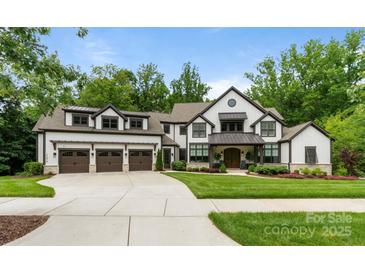 A beautiful two-story home with a three-car garage and manicured lawn in a well-developed neighborhood at 17416 Gillican Overlook Rd, Davidson, NC 28036