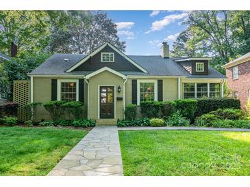 Charming home with a well-manicured lawn and stone walkway leading to the front door at 1809 The Plaza None, Charlotte, NC 28205