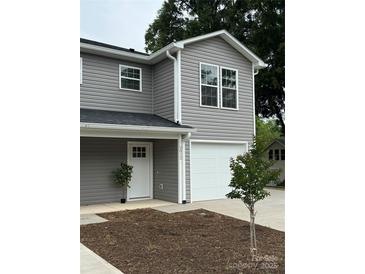 Charming two-story home with gray siding, white trim, and a one-car garage with a freshly landscaped yard at 2012 Crown Point Dr # A, Albemarle, NC 28001