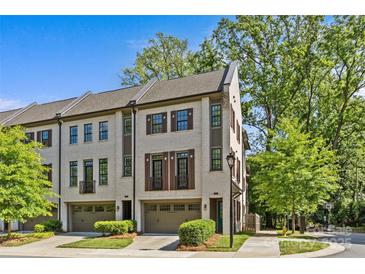 Beautiful exterior view of brick townhomes with attached garages and lush green landscaping at 2906 Hillside Springs Dr, Charlotte, NC 28209
