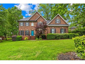 Beautiful two-story brick home with a well-manicured lawn and a charming blue front door at 4339 Shannamara Dr, Matthews, NC 28104