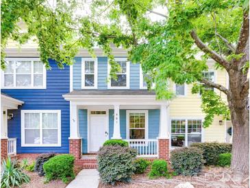 Charming townhome with a colorful exterior, front porch, and landscaped yard at 461 Hurston Cir # 51, Charlotte, NC 28208