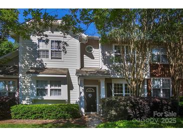 Charming home featuring a welcoming front porch, fresh landscaping, and neutral siding at 4938 Sunset Ridge Ct, Charlotte, NC 28269