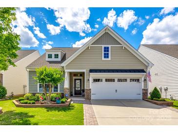 Charming single-Gathering home with a well-manicured lawn, two-car garage, and delightful landscaping at 5025 Kinross Ln, Indian Land, SC 29707