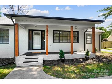 Front porch featuring wood posts and newly landscaped garden bed at 5428 Barnsdale Ln, Mint Hill, NC 28227