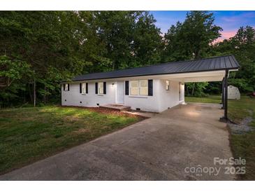 Charming one-story home with white brick, black shutters and a convenient carport at 565 Vine Arden Dr, Salisbury, NC 28146