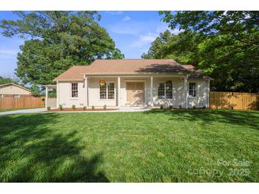 Charming single-story home with a well-manicured lawn and inviting curb appeal at 6100 Ashcrest Dr, Charlotte, NC 28217