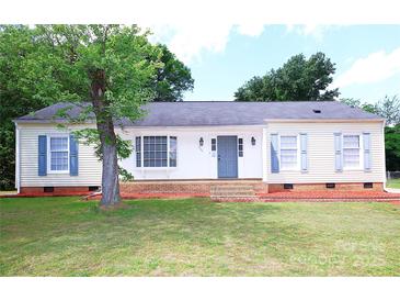 Charming one-story home featuring a well-maintained lawn, classic shutters, and a welcoming front entrance at 6124 Coach Hill Ln, Charlotte, NC 28212