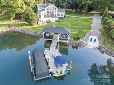 Stunning waterfront property with a private dock, boat lift, and covered outdoor living area at 108 Balmoral Dr, Mooresville, NC 28117