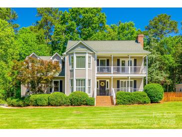 Charming two-story home with a welcoming front porch and beautifully landscaped front yard at 1355 Woodrun Ct, Rock Hill, SC 29732