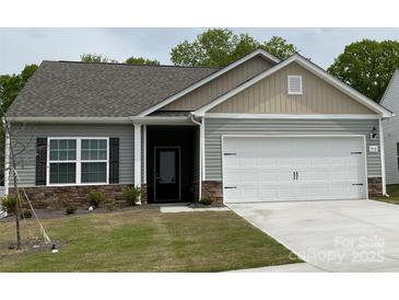 Charming one-story home featuring a two-car garage, stone accents, and well-maintained lawn at 1578 Doran Ter, Richburg, SC 29729