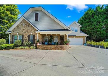 Charming brick home features a two-car garage, large front porch, and well-maintained landscaping at 286 Liverpool Rd, Rock Hill, SC 29730