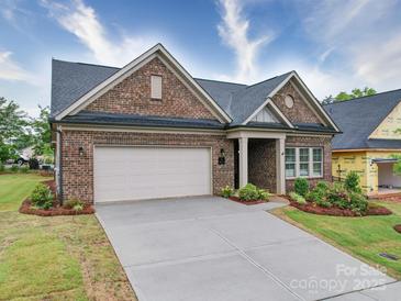 Charming single Gathering home features brick facade, manicured landscaping, and two-car garage at 405 Newstyle Way, Gastonia, NC 28056
